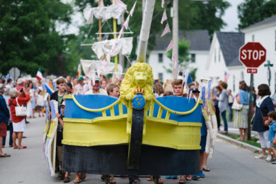 Children's model of L'Hermione leading the parade.