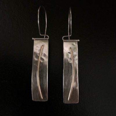 These beautiful earrings are made from hammered sterling with 14K gold wire hanging from hand-fabricated sterling tube and wire swing arms. Earring dimensions are 2 ¼” long x 1 ½” wide. Designed and donated by Lisa Friedman, https://lsfdesignandfabrication.com/