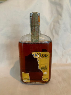 A similar bottle of Old Taylor bourbon sold at Sotheby's recently for $800. Old Taylor Bourbon was named in honor of Edmund Haynes Taylor, one of Kentucky’s original bourbon aristocrats and the “father of the modern bourbon industry.” In 1894, Taylor and his sons organized a corporation under the name of “E. H. Taylor, Jr. & Sons”. Donated by Rev Courtley.
